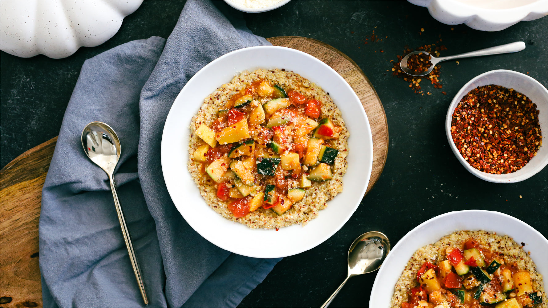 A feast of zucchini and tomatoe "ratatouille" served over a hearty bowl of polenta