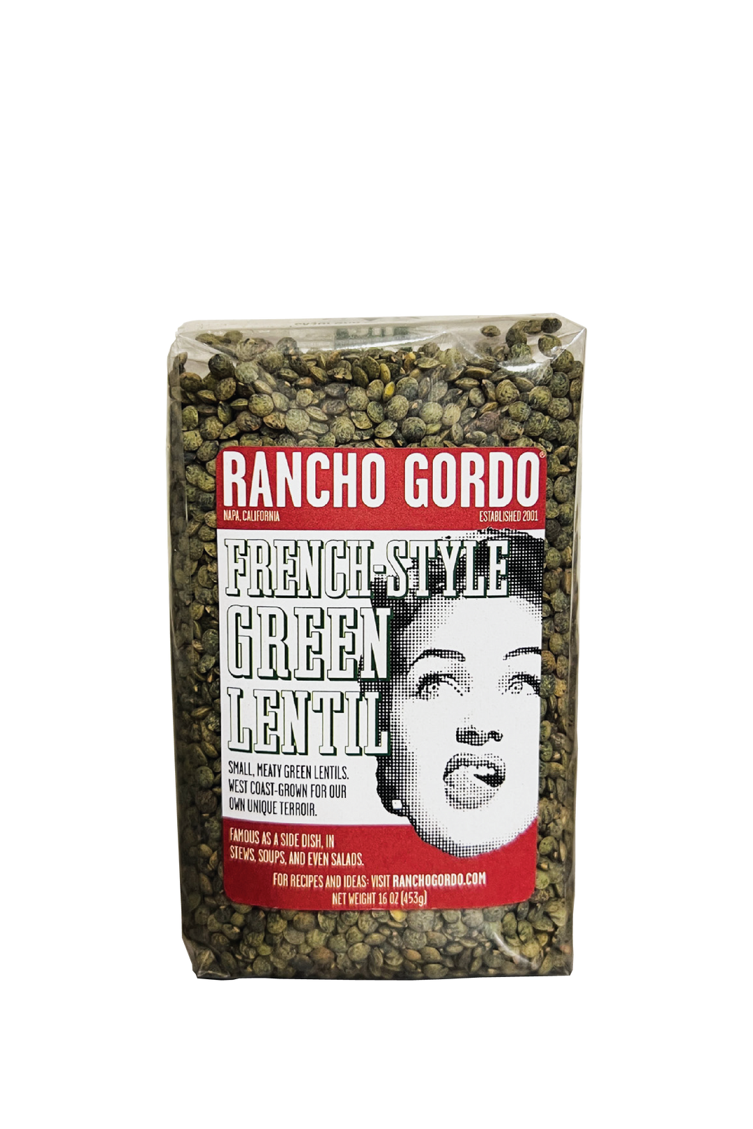 A One Pound Bag of Rancho Gordo French-Style Green Lentils on a white background. Red and white label with an image of the face of a woman licking her upper lip. Additional text on bag reads: Small, meaty green lentils. West Coast-grown for our own unique terroir. Famous as a side dish, in stews, soups, and even salads.