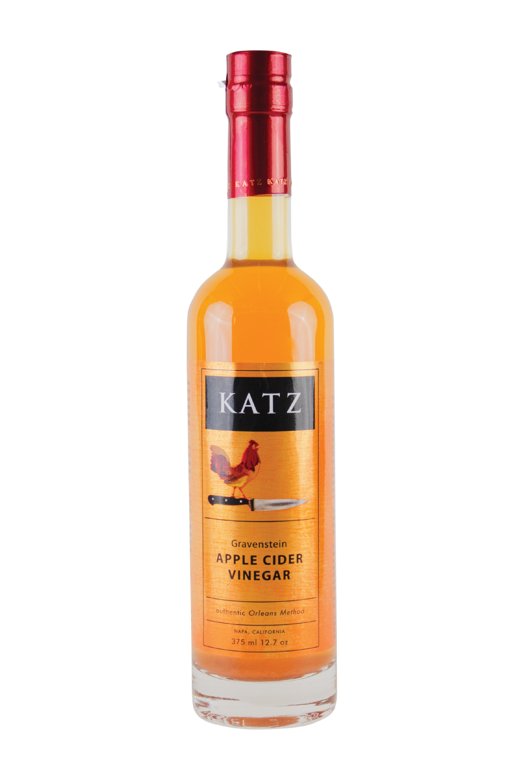 A 375 ml/12.7 oz glass bottle of Katz Gravenstein Apple Cider Vinegar on a white background. Label is dark gold and black with the image of a rooster standing on the hilt of a chef's knife and the words, "Authentic Orleans Method" and "Napa, California" on the bottle. Vinegar is a bright marigold orange, visible through the clear glass bottle with red foil shrink wrap on the top with the word "Katz" printed around the circumference.