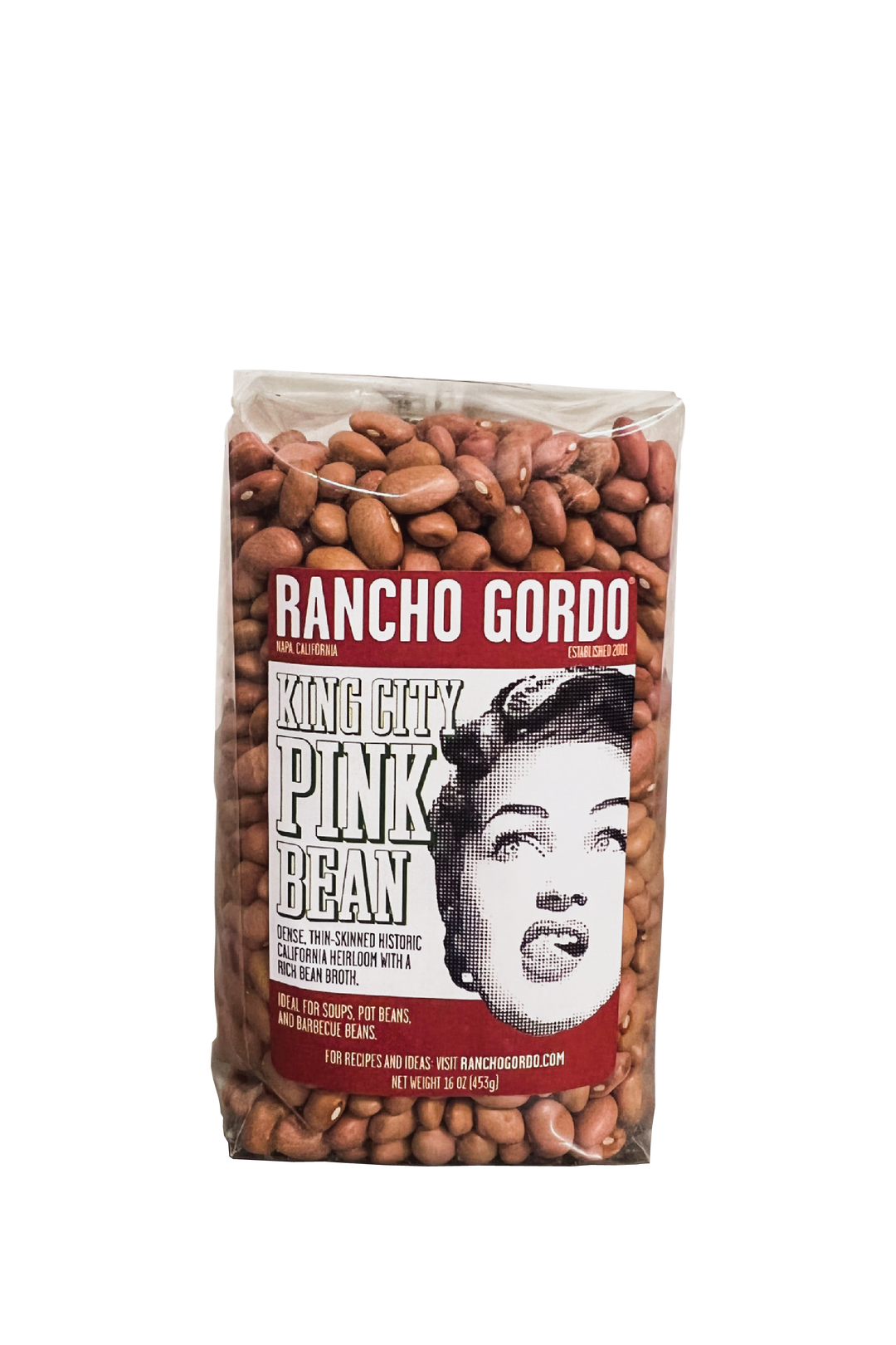 A One Pound Bag Of Rancho Gordo  King City Pink Beans on a white background. Red and white label with an image of the face of a woman licking her upper lip. Additional text on bag reads: Dense, thin-skinned historic California heirloom with a rich bean broth. Ideal for soups, pot beans, and barbecue beans.