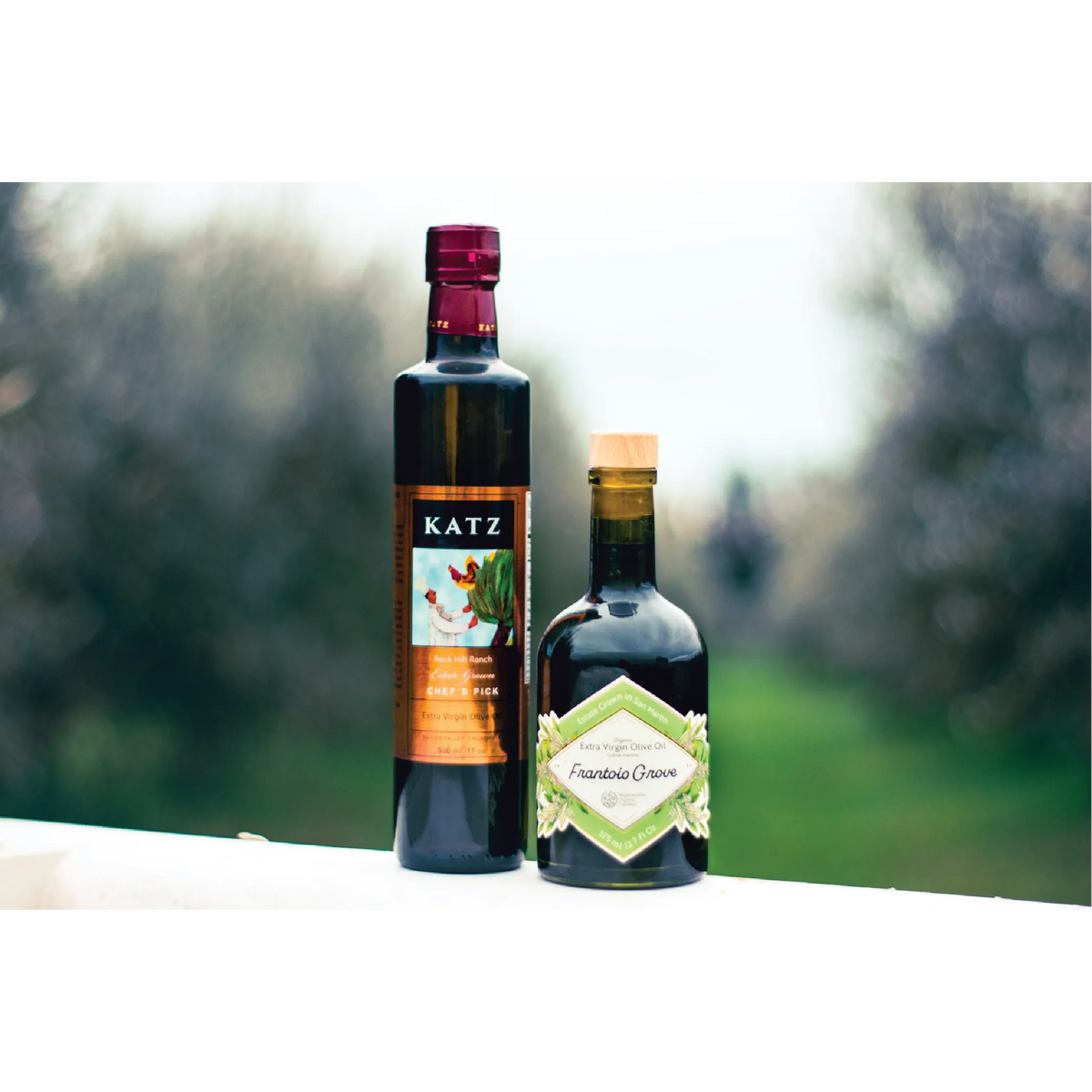 KATZ Chef's Pick and Frantoio Grove extra virgin olive oil bottles outdoors.