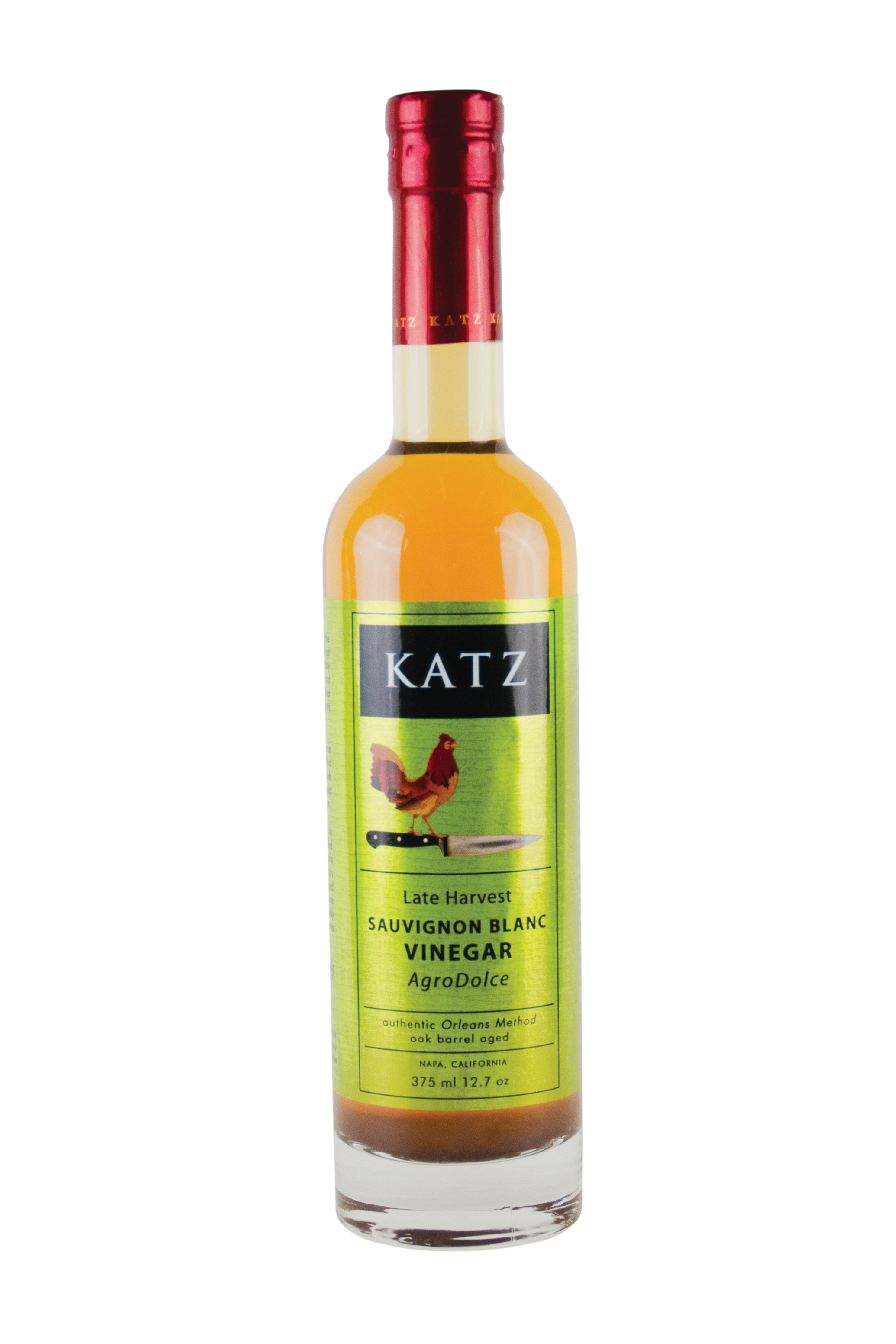A 375 ml/12.7 oz glass bottle of Katz Late Harvest Sauvignon Blanc Agrodolce Vinegar on a white background. Label is light metallic green and black with the image of a rooster standing on the hilt of a chef's knife and the words, "Authentic Orleans Method, oak barrel aged" and "Napa, California" on the bottle. Vinegar is a muted yellow-orange, visible through the clear glass bottle, with red foil shrink wrap on the top with the word "Katz" printed around the circumference.