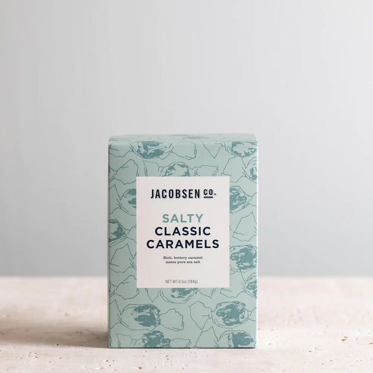 A Box of Jacobsen Salt Co's Salty Classic Caramels on a stone surface